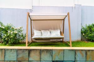 a porch swing with two pillows on the grass at Cosy Corner Sandton in Vosburg