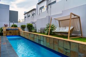 a swimming pool with a bed on the side of a house at Cosy Corner Sandton in Vosburg