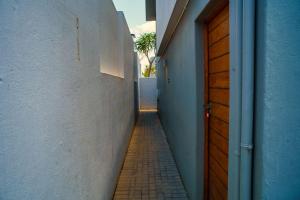 a hallway of a building with a door and a sidewalk at Cosy Corner Sandton in Vosburg +5 photos