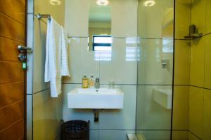 a bathroom with a sink and a shower at Cosy Corner Sandton in Vosburg