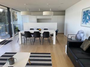 a living room with a white table and chairs at WATERFRONT Home in Nelson