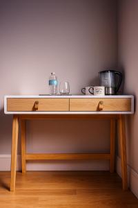 a wooden table with a counter top in a room at Central Guest Studio - En-Suite - Vibrant London in London