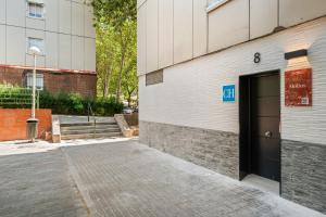 a building with a door on the side of it at Dobo Madrid Molins in Madrid