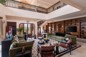 a living room with couches and a tv at Villa Sol- A Hilltop Villa in Udaipur in Jāmb