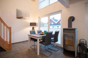 a dining room with a table and a wood stove at VechteSonne - Nordhorn in Nordhorn