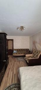 a bedroom with two beds and a ceiling at 1 комнатная квартира in Turksib