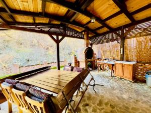 a dining room with a wooden table and chairs at Hanul lui Traian in Voineasa