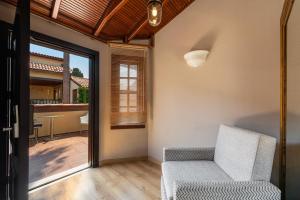 a living room with a chair and a balcony at Alp Pasa Hotel - Special Class in Antalya