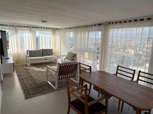 a living room with a table and chairs and a couch at Horizon d'Ankadifotsy in Antananarivo