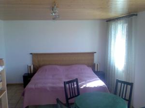 a bedroom with a bed and two chairs and a window at Chambre d'hôtes Littoral 65 in Chez-le-Bart