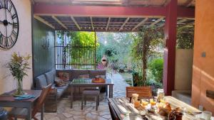 a patio with a table with a laptop on it at Le Logis Du Four in Soudan