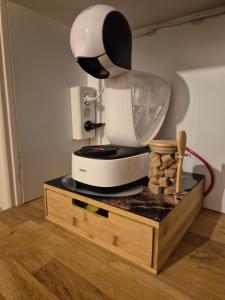 a white mixer sitting on top of a wooden stand at Loveroom Eclat d emoi in Condé-sur-Noireau