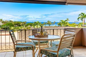 a table and chairs on a balcony with a view of the ocean at Maui Eldorado Condo K218 in Kaanapali