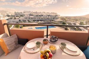 a table with a bowl of fruit on a balcony at Ático de proa, en la mejor playa del Médano in Granadilla de Abona