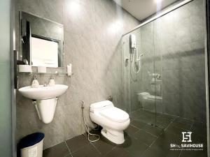 a bathroom with a toilet and a sink and a shower at 5H Garden in Ho Chi Minh City