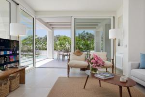 a living room with a couch and a table at Villa Mareiva - Heated Pool, Beach 150 mt in Pozzallo
