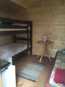a room with two bunk beds and a table at Valeria kamping in Uusküla