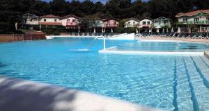a large swimming pool with a water fountain at Appartement T2 avec piscine privée et chauffée in Lacanau