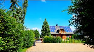 a house with a lot of solar panels on it at Perła Jezioraka Siemiany - Całoroczny 100m Apartament z linią brzegową, banią z jacuzzi i pomostem in Siemiany