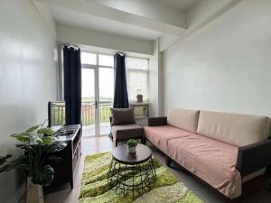 a living room with a couch and a table at Oceanview Condo in Boracay in Boracay +115 photos