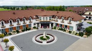 an aerial view of a building with a fountain at Hotel Sebory in Przasnysz