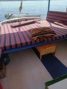 a bed on the back of a boat at Felucca Alaska in Aswan