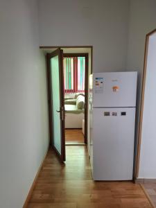 a white refrigerator in a room with a doorway at Casa Albert Litman in Sinaia