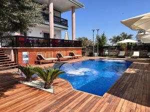 a swimming pool on a wooden deck next to a building at Cunda EYE in Cunda