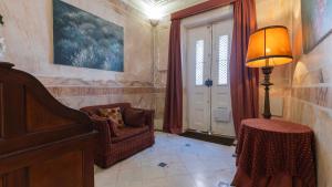 ein Wohnzimmer mit einem Stuhl und einer Lampe in der Unterkunft Garden Mansion in Historic Center by LovelyStay in Lissabon