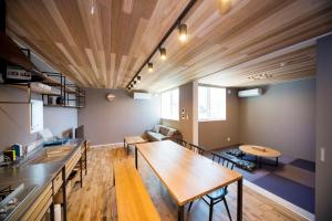 a kitchen and living room with a wooden ceiling at Rakuten STAY HOUSE x WILL STYLE Matsue 101 in Matsue