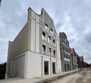 a large white building on the side of a street at HappyApartments - Malbork, Stare Miasto 35 in Malbork