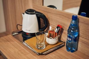 a coffee maker and a bottle of water on a counter at Hotel Lilia in Włoszczowa