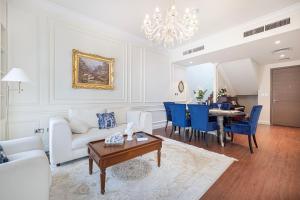 a living room with a couch and a table at Abu Dhabi 4BR Villa - Victorian-Inspired Stay in Abu Dhabi