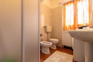 a small bathroom with a toilet and a sink at Ski Slopes 1km - Aprica Baradello Apartment for 6 guests in Le Bratte +10 photos