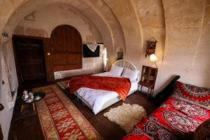 a bedroom with a bed in a small room at Katre Cave House in Ürgüp