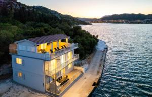 a house on the water next to a lake at Nice Home In Rogotin With Harbor View in Rogotin +20 photos