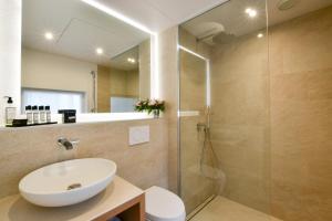 a bathroom with a sink and a shower at Victoire & Germain in Paris +42 photos