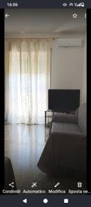 a living room with a couch and a television at Chloe's house in Agropoli