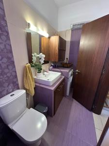 a bathroom with a white toilet and a sink at Sunset Apartments in Gourna +53 photos
