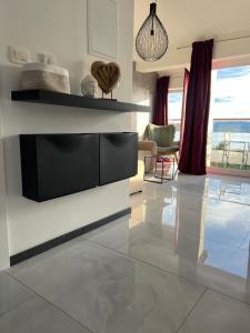 a living room with a television on a wall at SUNADOR - Adults Only in Crikvenica