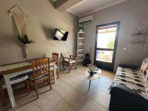 a living room with a couch and a table at Sunset Apartments in Gourna