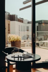 a table with a pair of glasses on top of it at Aethos London Shoreditch in London