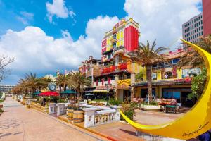 a city street with buildings and a yellow swing at Tsukasa Condo Chatan Alaha in Chatan