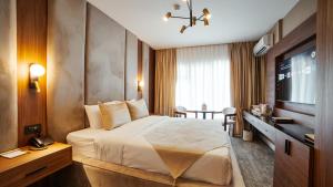 a hotel room with a bed and a television at White Breeze Hotel in Baku