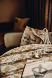 a bed with a pillow with the words filled with experience at Aethos London Shoreditch in London +63 photos