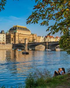 a bridge over a river in front of a building at Nice room E3 Prague 7 in Prague