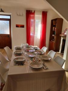 a table with plates and wine glasses on it at Casa sul lago - Appartamento Girasole, Parco della Majella in Fara San Martino