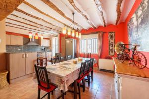 a kitchen and dining room with a long table and chairs at La Casica del Sol in Requena