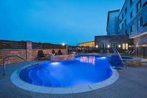 a large swimming pool in the middle of a building at Courtyard Dallas Grand Prairie in Grand Prairie