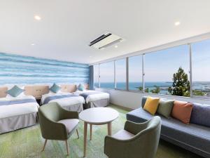 a hotel room with a view of the ocean at KAMENOI HOTEL Yaizu in Yaizu
